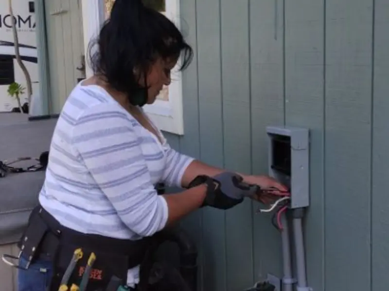 Licensed electrician wiring an exterior subpanel in Colby
